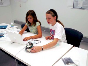 UNT RoboCamp - girls with robot at computers