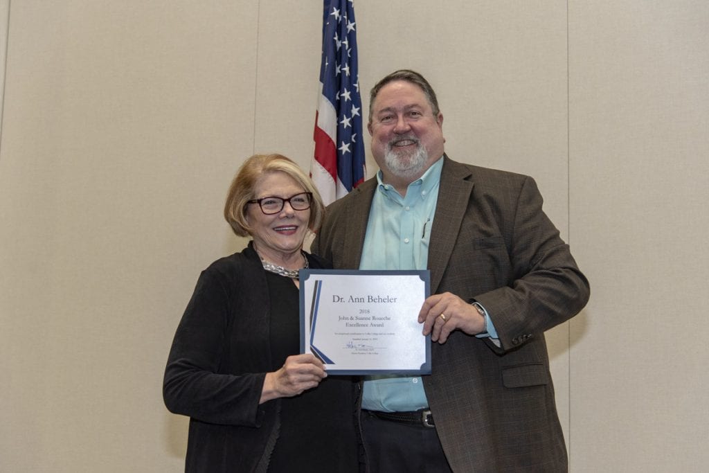 Dr. Ann Beheler pictured here receiving the John & Suanne Roueche Excellence Award from Collin College President, Dr. Neil Matkin. 