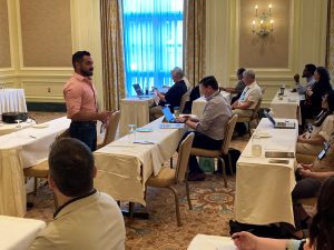 In a Grand America ballroom in Salt Lake City, data scientist Aaron Burciaga leads a workshop on data science and AI.