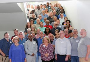 Group photo of CCN educators posed on a Collin Colleg stairwell during the July 2019 in-person meeting.