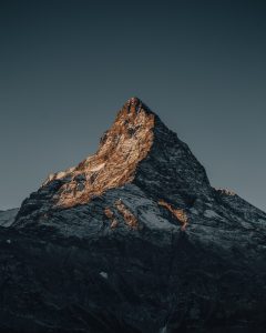 Stock photo of a mountain peak at sunset.