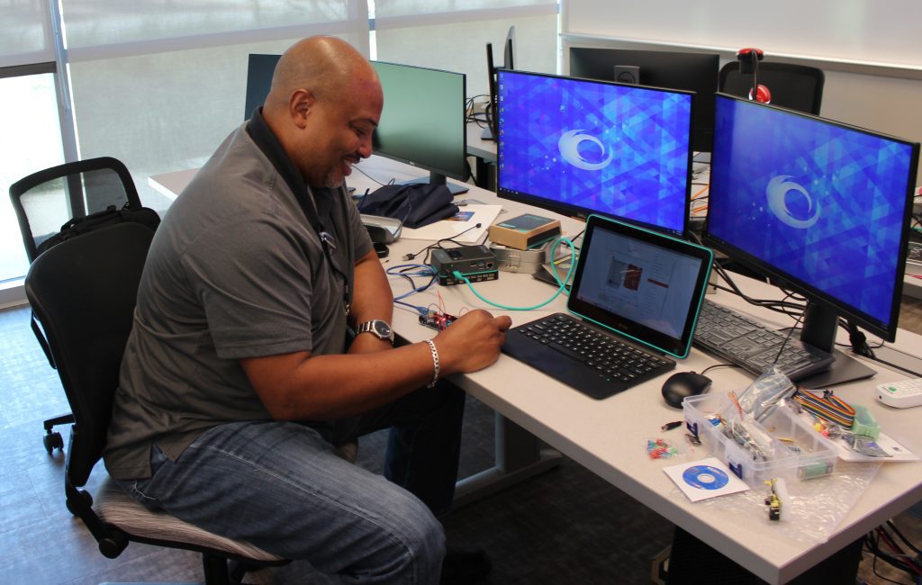 A faculty students sits at a computer work station configuring a Raspberry Pi at Summer Working Connections in July 2022.