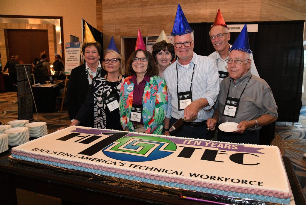 NSF grant PIs gather around a big birthday cake, celebrating the 10th birthday of the HITEC conference.